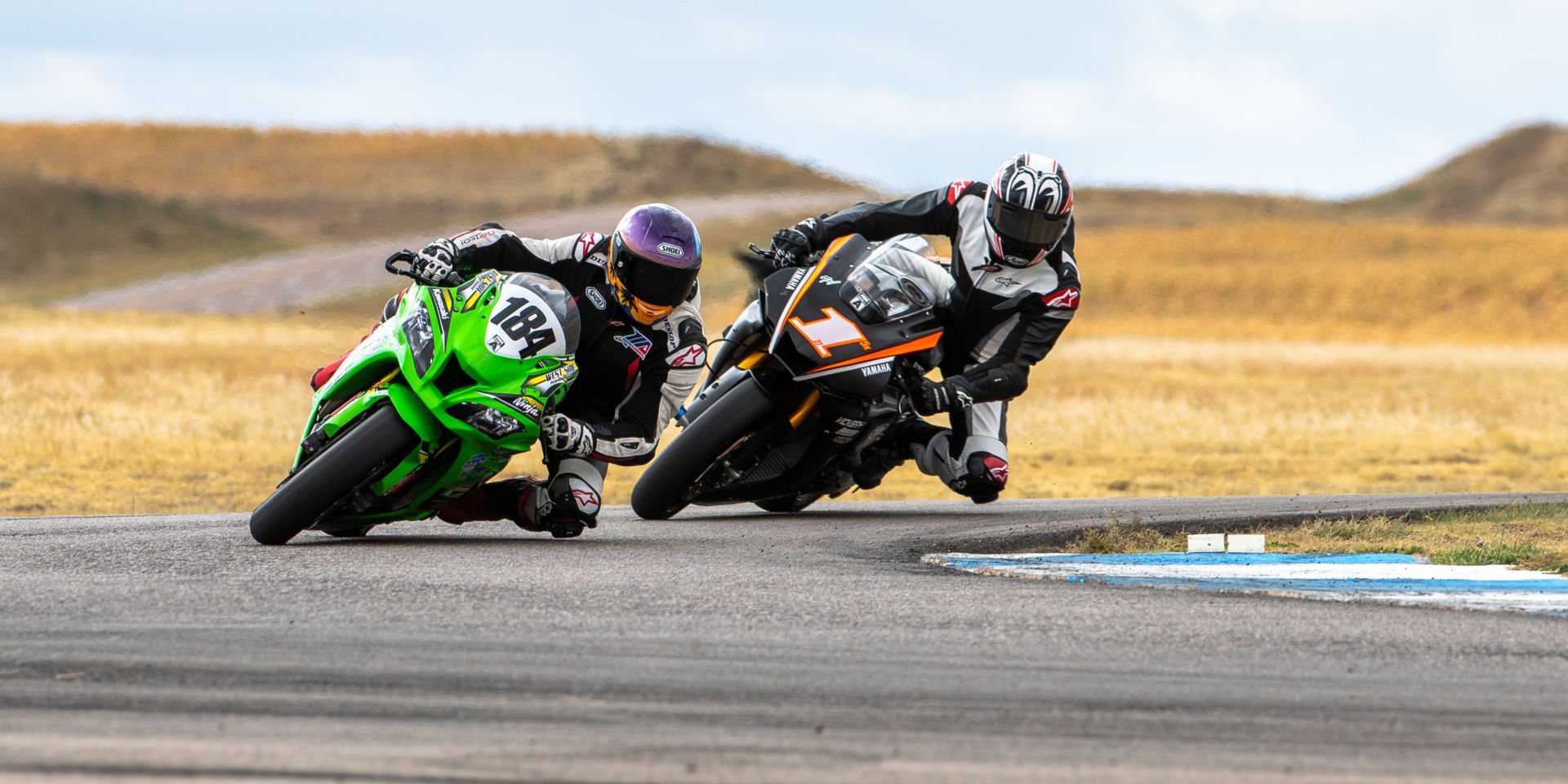 Andrew Lee (184) leading Ryan Burke (1) in the Race of the Rockies at High Plains Raceway. Photo by Luke Hummel Photography, courtesy MRA.