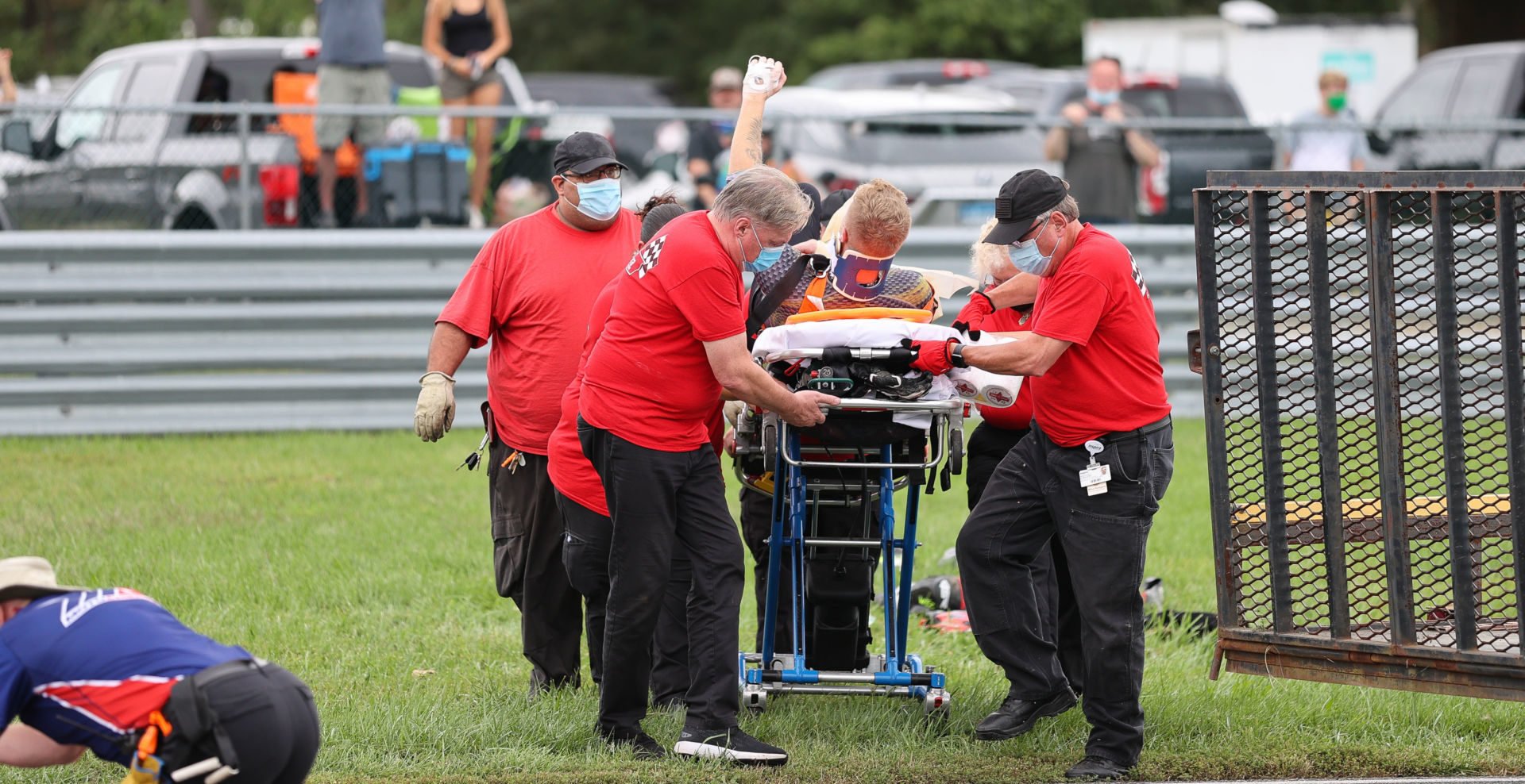 Bradley Ward raises his fist to acknowledge cheering fans as medical workers attend to him after his crash in MotoAmerica Superbike Race Two at New Jersey Motorsports Park. Photo by Brian J. Nelson, courtesy Bradley Ward Racing.