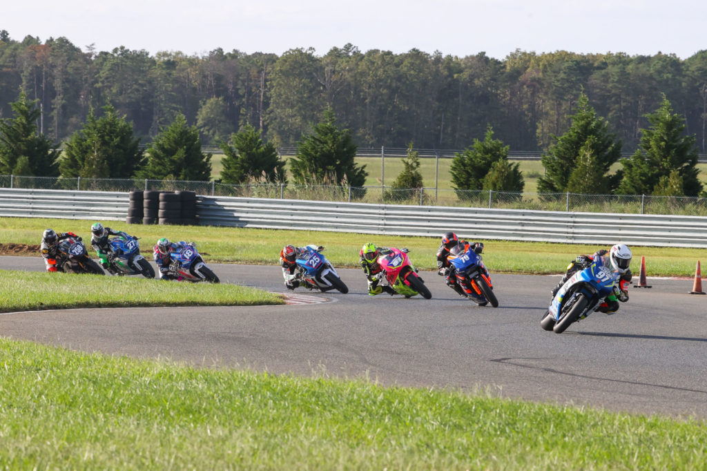 Rocco Landers (97) leads Teagg Hobbs (79), Kaleb De Keyrel (51), Dominic Doyle (25), Jackson Blackmon (18), Toby Khamsouk (27), and Hayden Schultz (259) at the start of Twins Cup Race One. Photo by Brian J. Nelson, courtesy MotoAmerica.