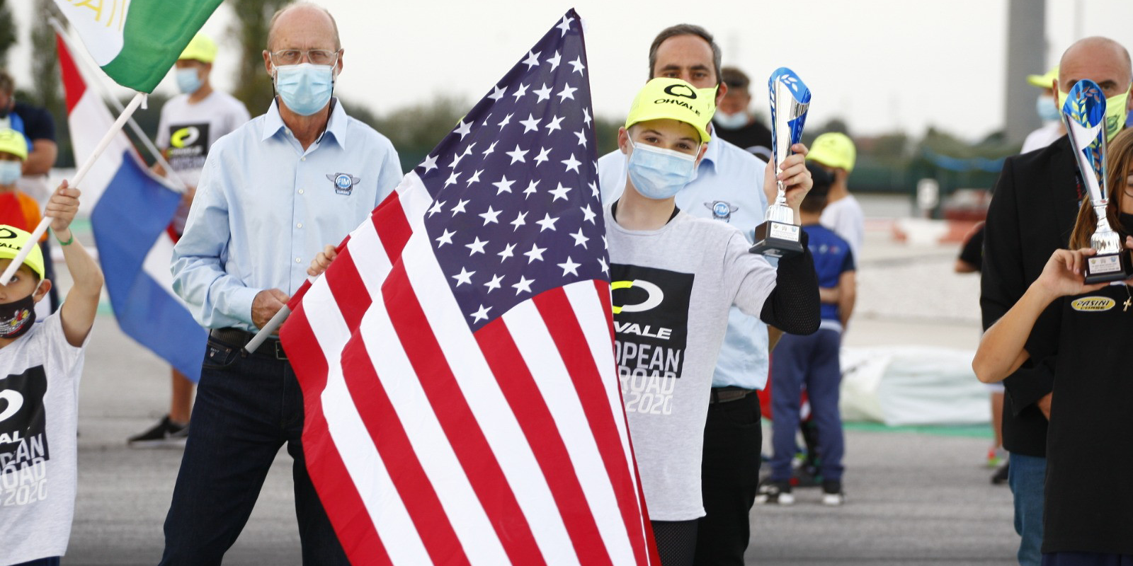 Rossi Moor holding his pole position award and an American flag at Adria International Raceway Kart Track in Italy. Photo courtesy of Rossi Moor.