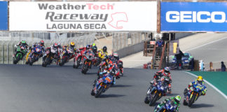 Cameron Beaubier (1) leads Toni Elias (24), Jake Gage (32), Lorenzo Zanetti (behind Gagne), Bobby Fong (50), Kyle Wyman (behind Fong), Niccolo Canepa (behind Wyman), Josh Herrin (2), and the rest of the HONOS Superbike field during a race start Sunday at Laguna Seca. Photo by Brian J. Nelson, courtesy MotoAmerica.