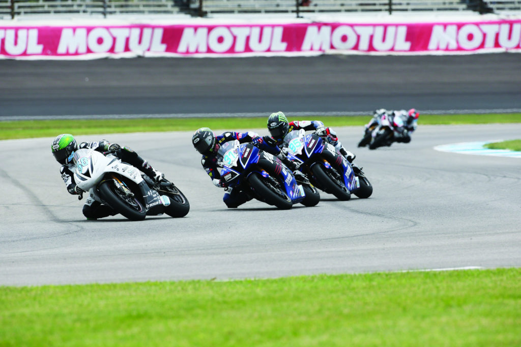 Bobby Fong (50) leads Garrett Gerloff (31) and JD Beach (95) into Turn Two during the lone MotoAmerica Supersport race at Indianapolis Motor Speedway in 2015. Photo by Brian J. Nelson.