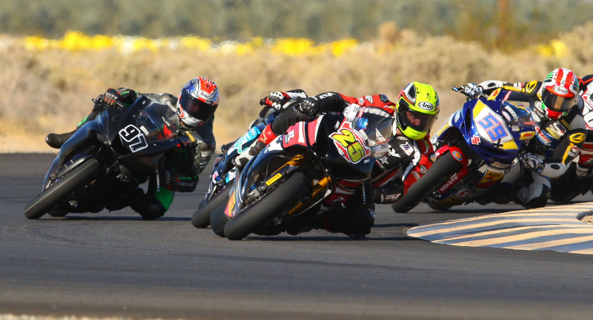 David Anthony (25) leads Michael Gilbert (97), Rocco Landers (behind Anthony), Jaret Nassaney (59x) and the rest of the field at the start of the CVMA Shootout race December 6 at Chuckwalla Valley Raceway. Photo by CaliPhotography.com, courtesy CVMA.