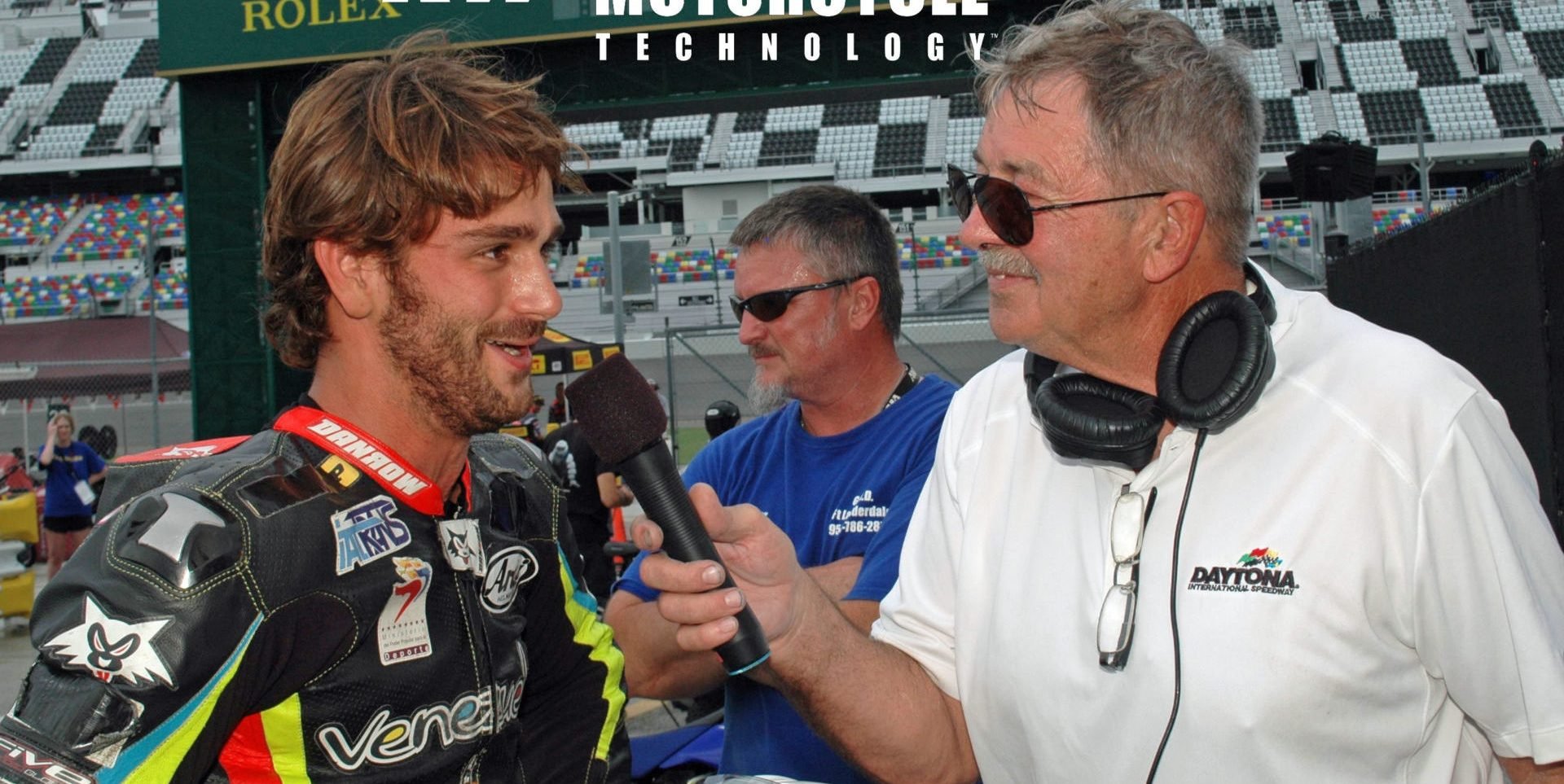 Daytona International Speedway public address announcer and former racer Richard Chambers (right) interviewing former Latin America Superbike Champion and current Sporting Director for the Italtrans Racing Moto2 World Championship team Robertino Pietri (left) at Daytona International Speedway in 2016. Photo by David Swarts.