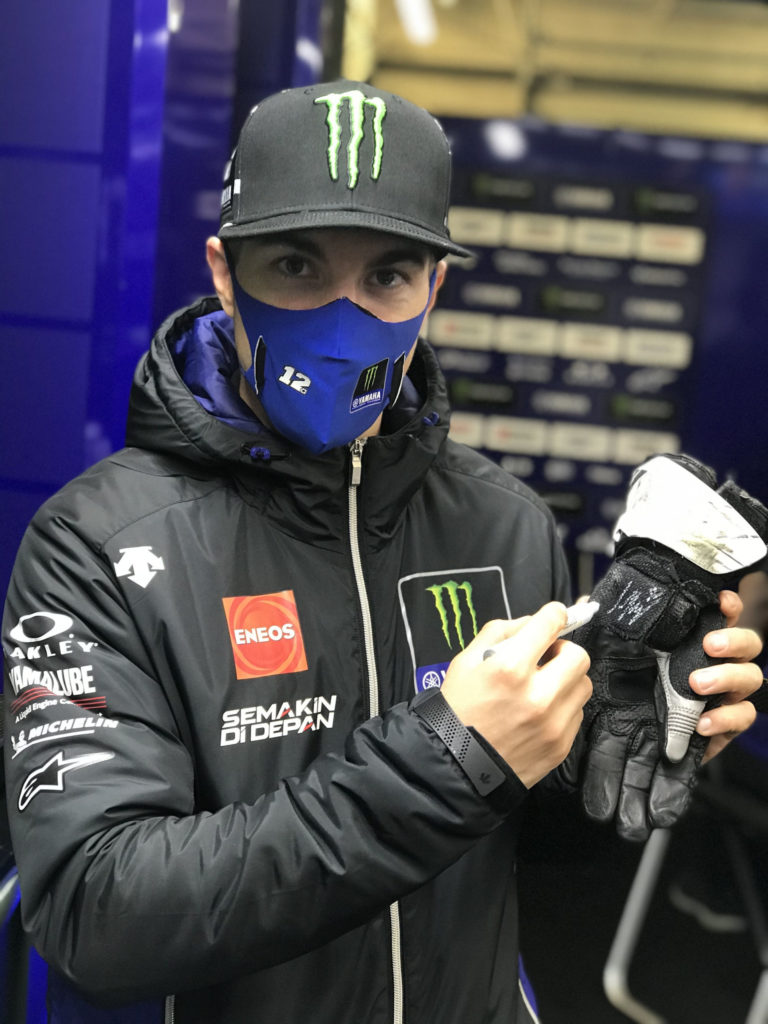 Maverick Vinales with an autographed glove. Photo courtesy Dorna.