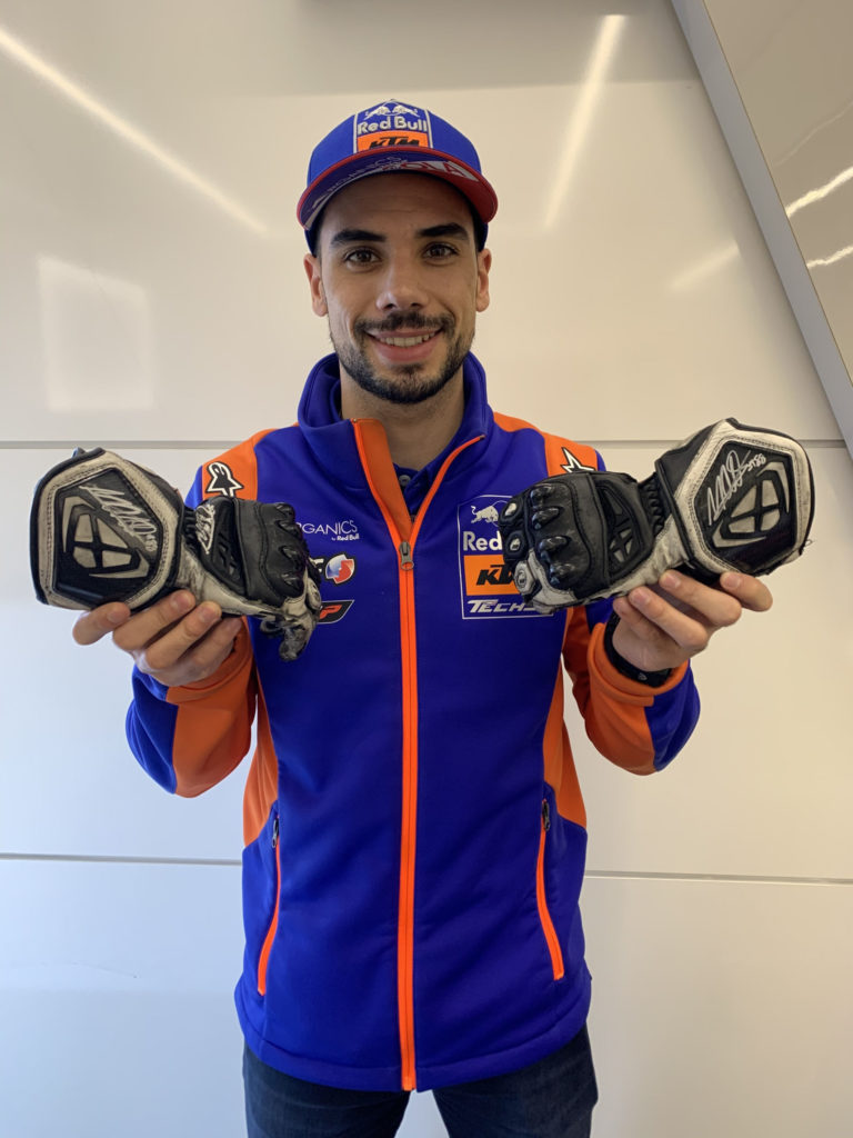 Miguel Oliveira with autographed gloves. Photo courtesy Dorna.
