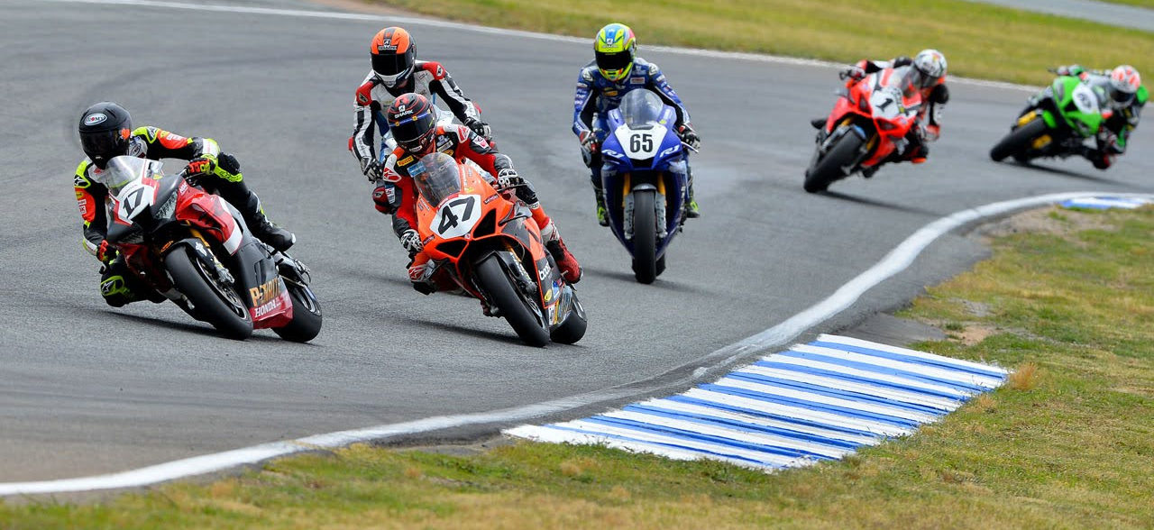 Troy Herfoss (17) leads Wayne Maxwell (47), Glenn Allerton, Cru Halliday (65), and Mike Jones (1) during a race at Wakefield Park. Photo by Russell Colvin, courtesy Motorcycling Australia.
