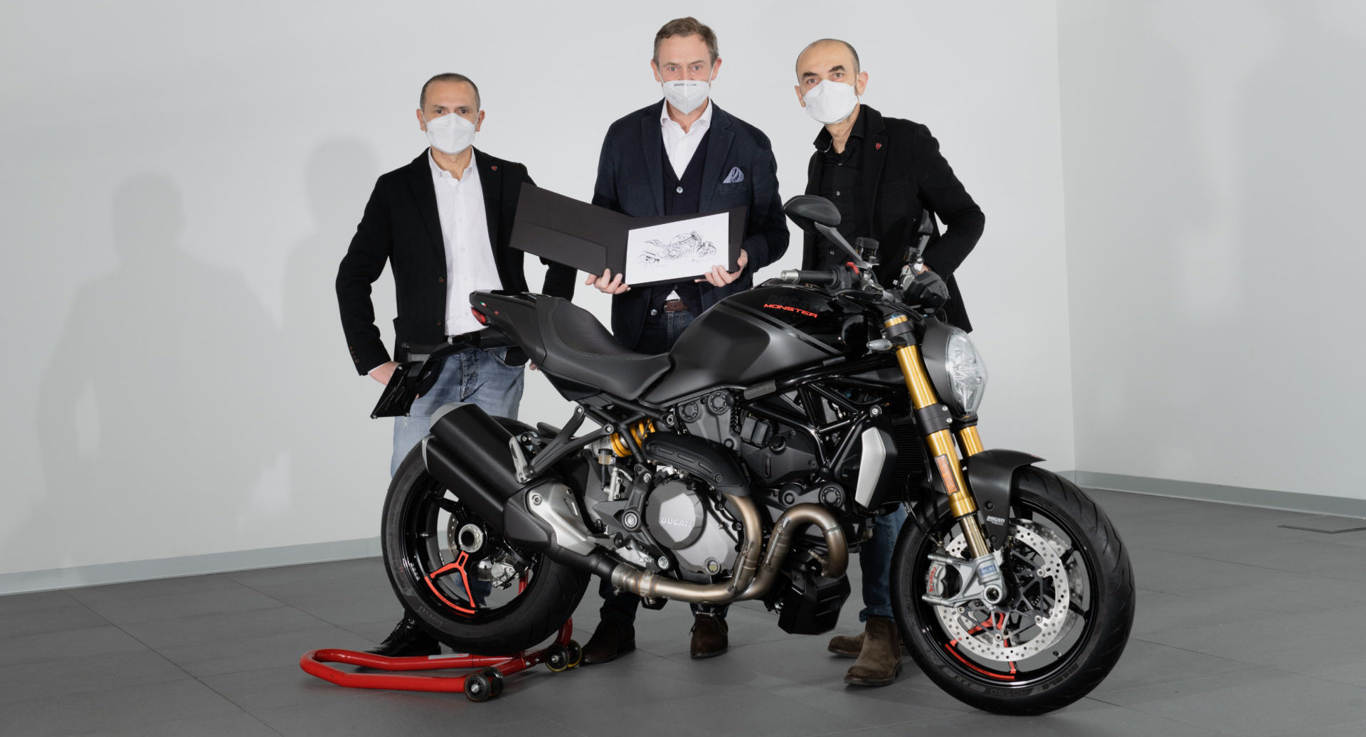 Ducati CEO Claudio Domenicali (right) and Ducati Design Center Director Andrea Ferraresi (left) deliver the 350,000th Ducati Monster to its new owner Sebastien Francois Yves Hervé De Rose (center). Photo courtesy Ducati.