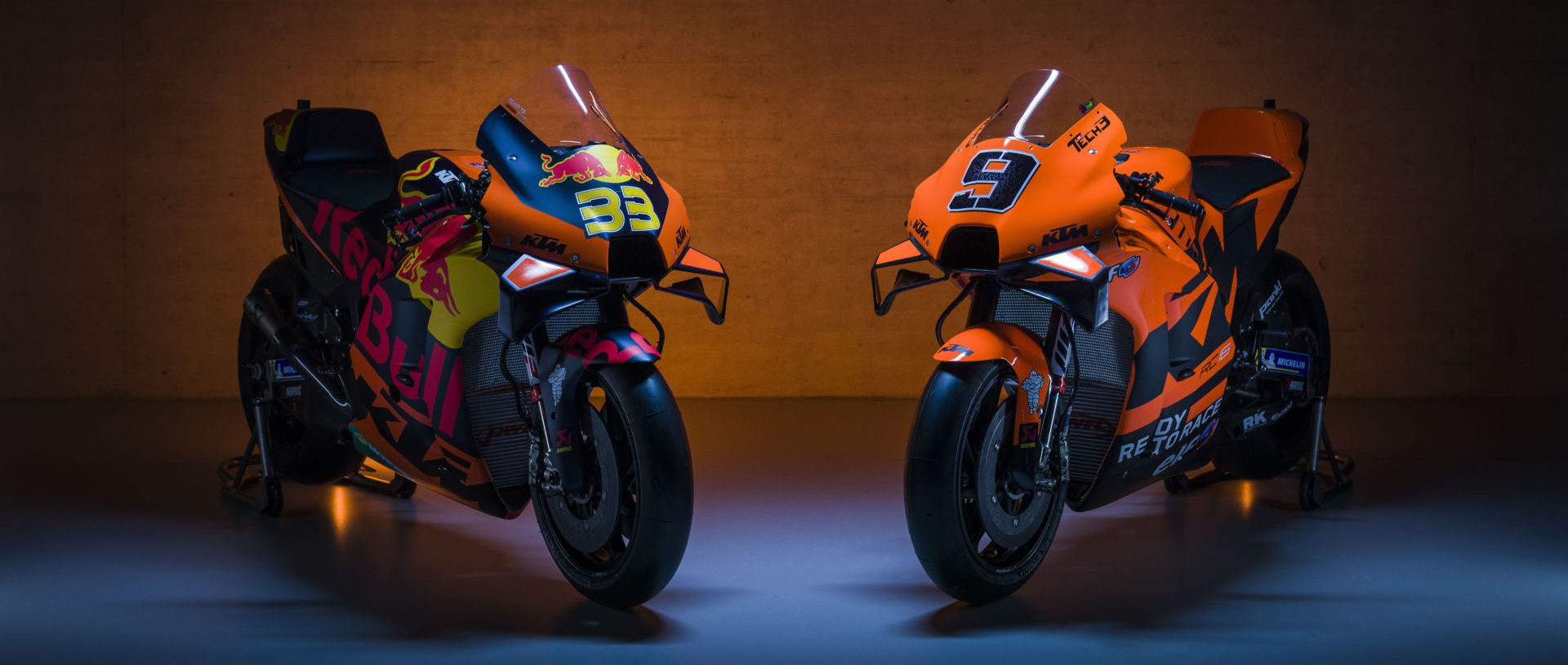 The 2021 KTM RC16 MotoGP racebikes of Brad Binder (33) and Danilo Petrucci (9). Photo by Sebas Romero, courtesy KTM Factory Racing.