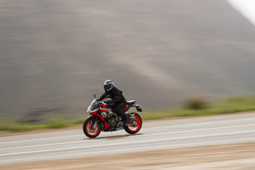 The Aprilia Tuono 660's riding position is more upright than that of the sister RS 660, but is still comfortable at speed. The abbreviated bodywork provides good wind protection and well-incorporated downforce elements at the front. Photo by Larry Chen.