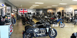 The D&D Cycles showroom in Pensacola, Florida, with Triumph, MV Agusta, and Aprilia models on display, and Rob McLendon at his desk in the background. Photo by Dalton Gauthier.