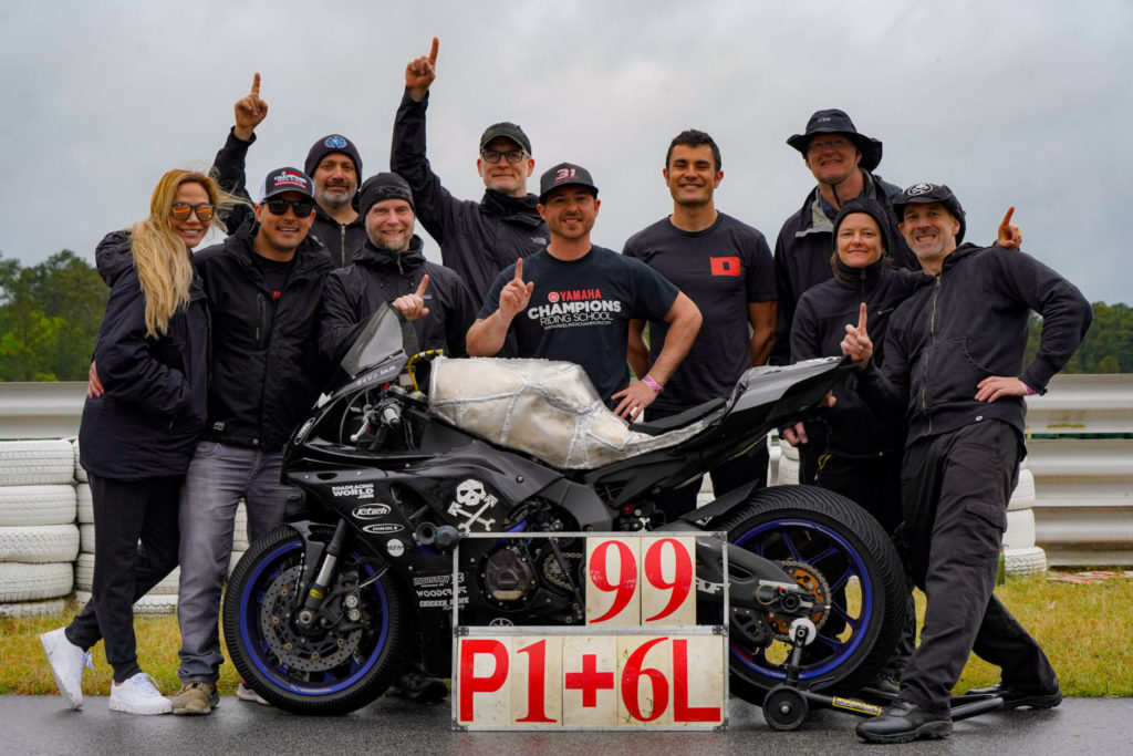 (From left) Jennifer Peris, Chris Peris, Anthony Consorte, YT Lechner, Chris Manfrin, Ben Walters, Xavier Zayat, Tim Gooding, Melissa Berkoff, Sam Fleming and “Gaijin” the endurance bike.  Note the hand hammered and laboriously engineered aluminum gas tank. Photo by Christopher Holder, courtesy AOD.