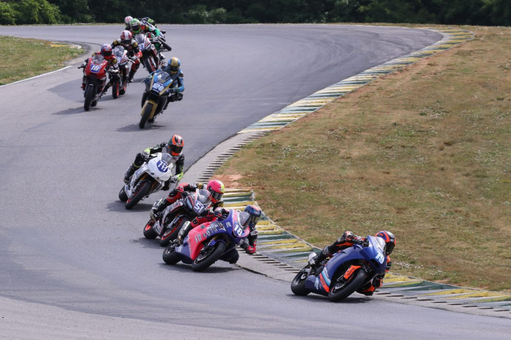 Teagg Hobbs (79) leads Jackson Blackmon (18), Kaleb De Keyrel (51), Jody Barry (717) and the rest of the MotoAmerica Twins Cup field early in Race One. Photo by Brian J. Nelson, courtesy MotoAmerica.