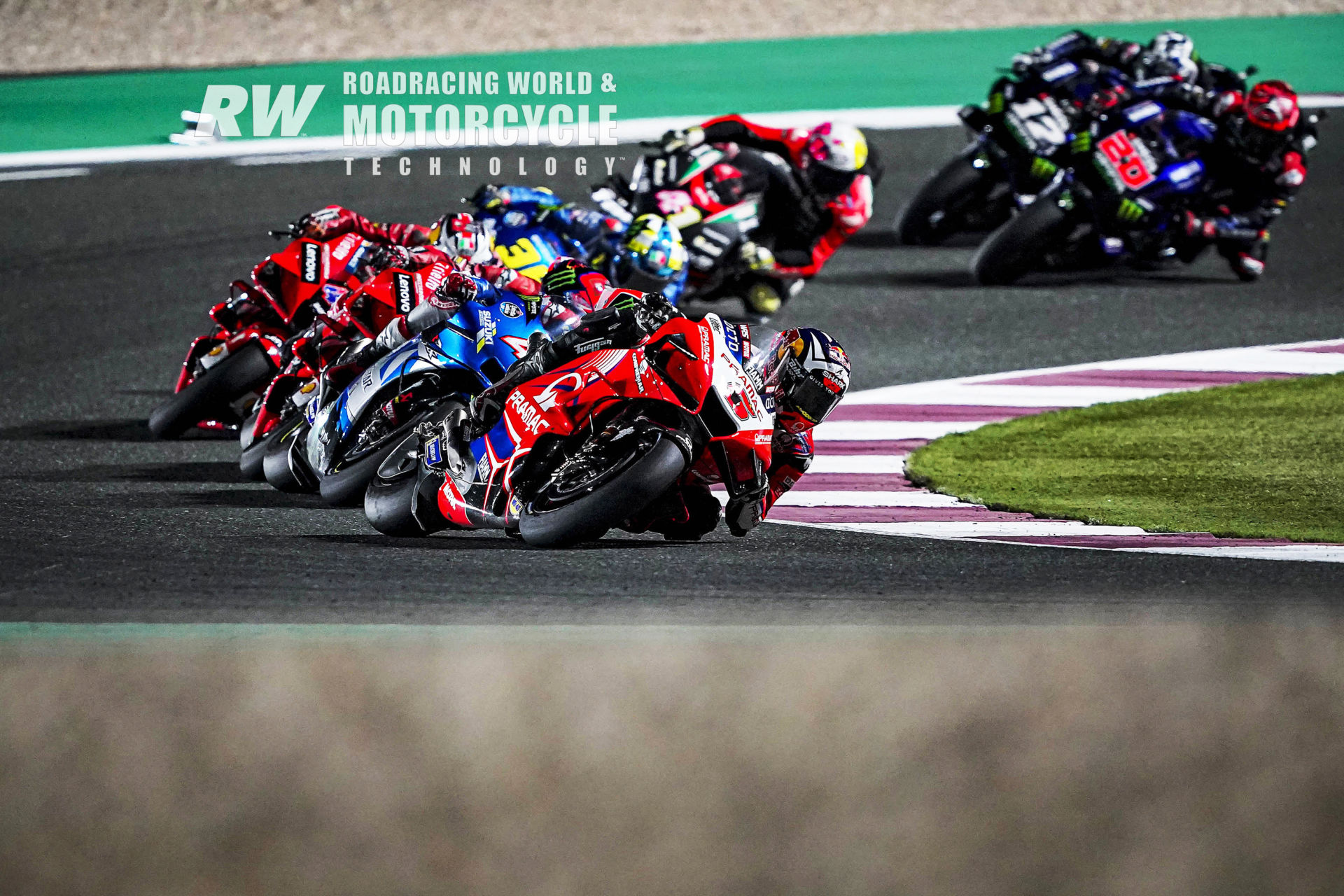 Second-quickest qualifier Johann Zarco (5) chases pole-sitter Jorge Martin (already out of the frame) and leads Alex Rins (42), Francesco Bagnaia, Jack Miller, Joan Mir (36) Aleix Espargaró (41), Fabio Quartararo (20), and Maverick Viñales (12) early in the Moto-GP race during Qatar weekend #2. Photo by DPPI Media.