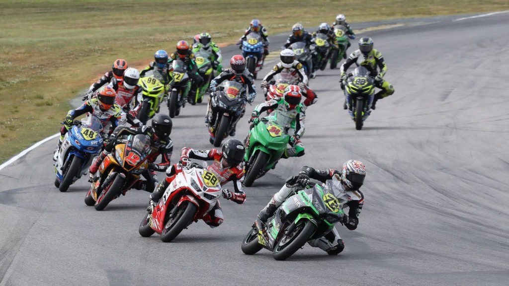 Ben Gloddy (72) leads Max Toth (58), Jack Roach (12), Max Vanderbrouck (48), Cody Wyman (34), and the rest of the SportbikeTrackGear.com Junior Cup field early in Race One at VIR. Photo by Brian J. Nelson, courtesy MotoAmerica.