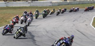 Jake Gagne (32) leads Kyle Wyman (33), Josh Herrin (2), Loris Baz (76), Travis Wyman (10), Hector Barbera (80), Bobby Fong (50) and the rest of the field at the start of Superbike Race Two. Photo by Brian J. Nelson, courtesy Yamaha.