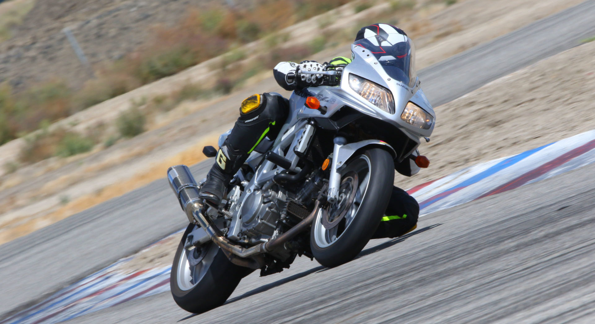 Even a well-used set of good performance radials can serve you well at a track day. The author on his beloved bargain blaster Suzuki SV650 with a set of year-old Dunlop RoadSport 2 radials at Buttonwillow Raceway Park. Photo by CaliPhotography.com.