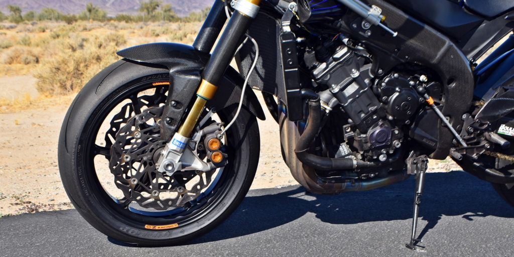 Öhlins forks, Braking rotors and carbon-fiber fork protectors. OZ Racing wheels carry Dunlop Sportmax Q4 track day radials. Photo by Michael Gougis.