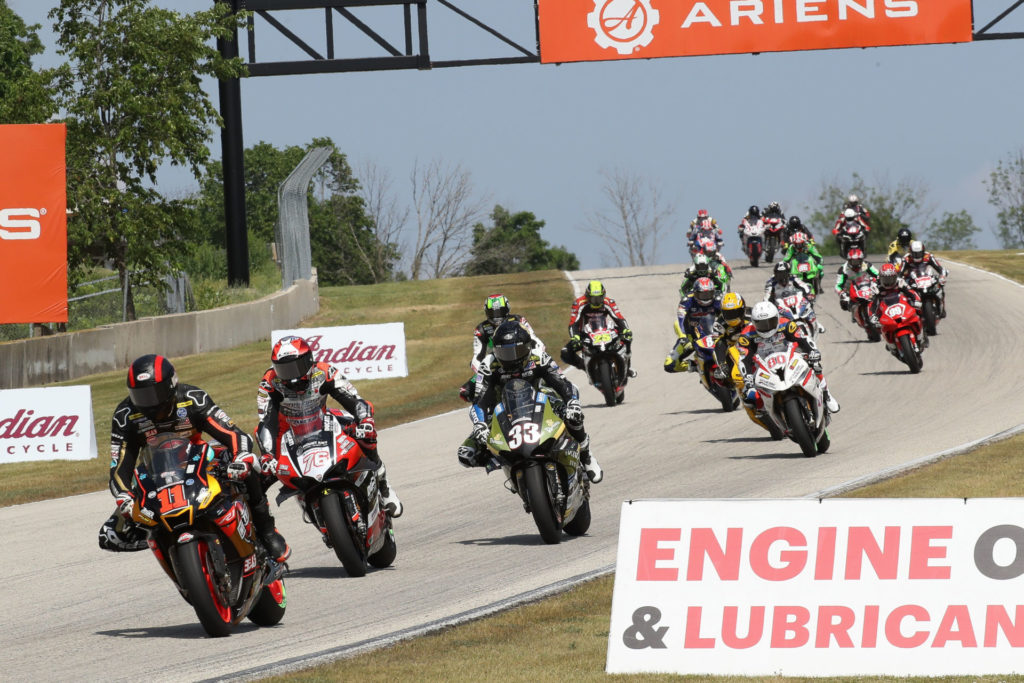 Matthew Scholtz (11) leads a group of riders during MotoAmerica Superbike Race One. Photo by Brian J. Nelson, courtesy Westby Racing.