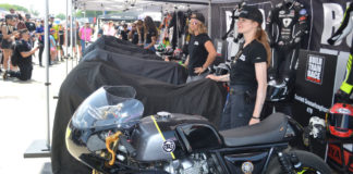 Royal Enfield Build Train Race (BTR) road race participants Scarlett Grosselangehorst (right) and Trisha Dahl (left) with their Royal Enfield Continental GT 650 racebike builds under covers. BTR program mentor Melissa Paris’ Royal Enfield racebike is in the foreground. Photo by David Swarts.