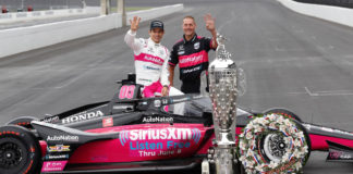 Former motorcycle road racer Perry Melneciuc (right) with 2021 Indy 500 race winner Helio Castroneves (left) and the Meyer Shank Racing #06 car at Indianapolis Motor Speedway the day after the race. Photo courtesy Meyer Shank Racing.