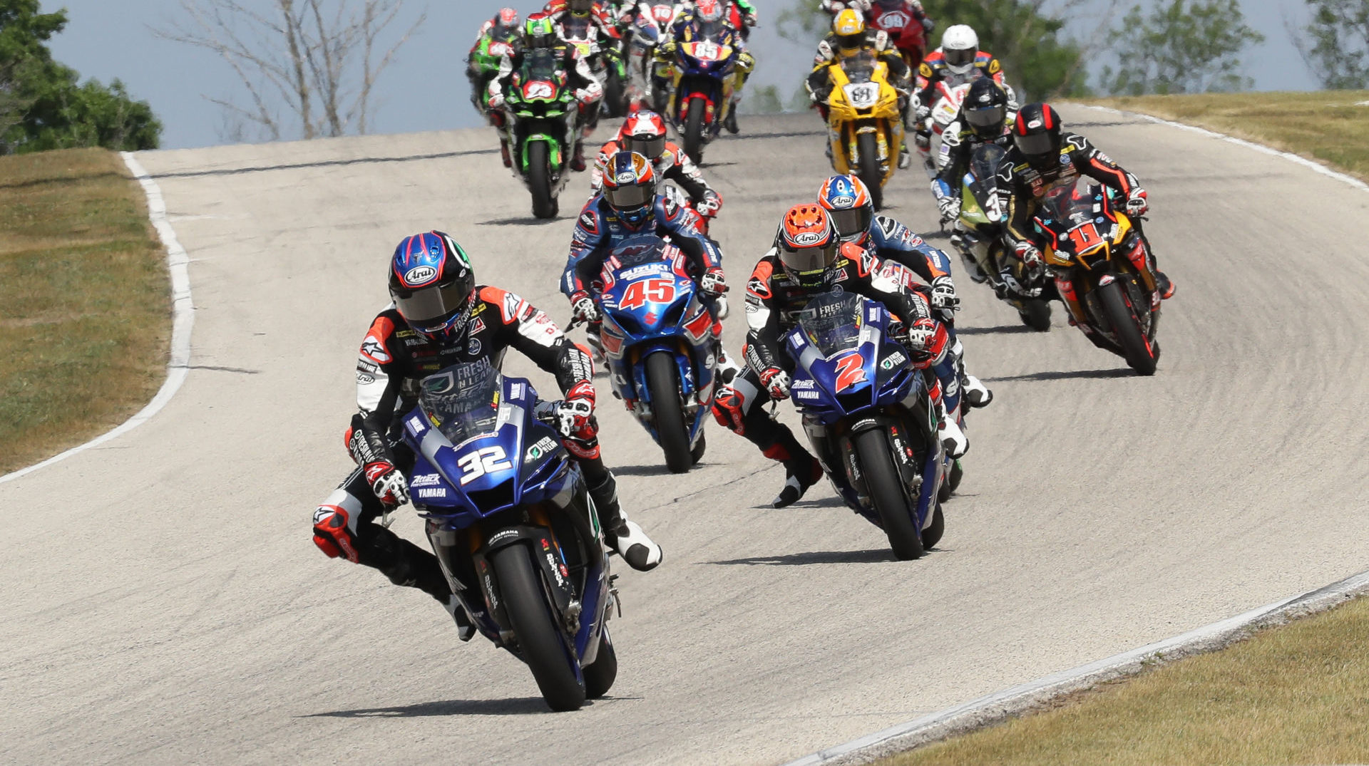 Jake Gagne (32) leads Josh Herrin (2), Cameron Petersen (45), and the rest of the field at the start of MotoAmerica Superbike Race One at Road America. Photo by Brian J. Nelson.