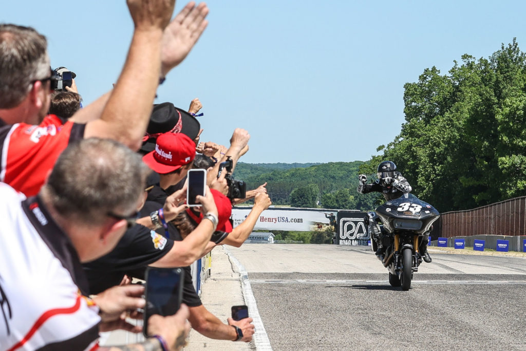 Kyle Wyman (33) acknowledging his crew along pit wall as he takes the checkered flag at Road America. Photo by Brian J. Nelson, courtesy Harley-Davidson.