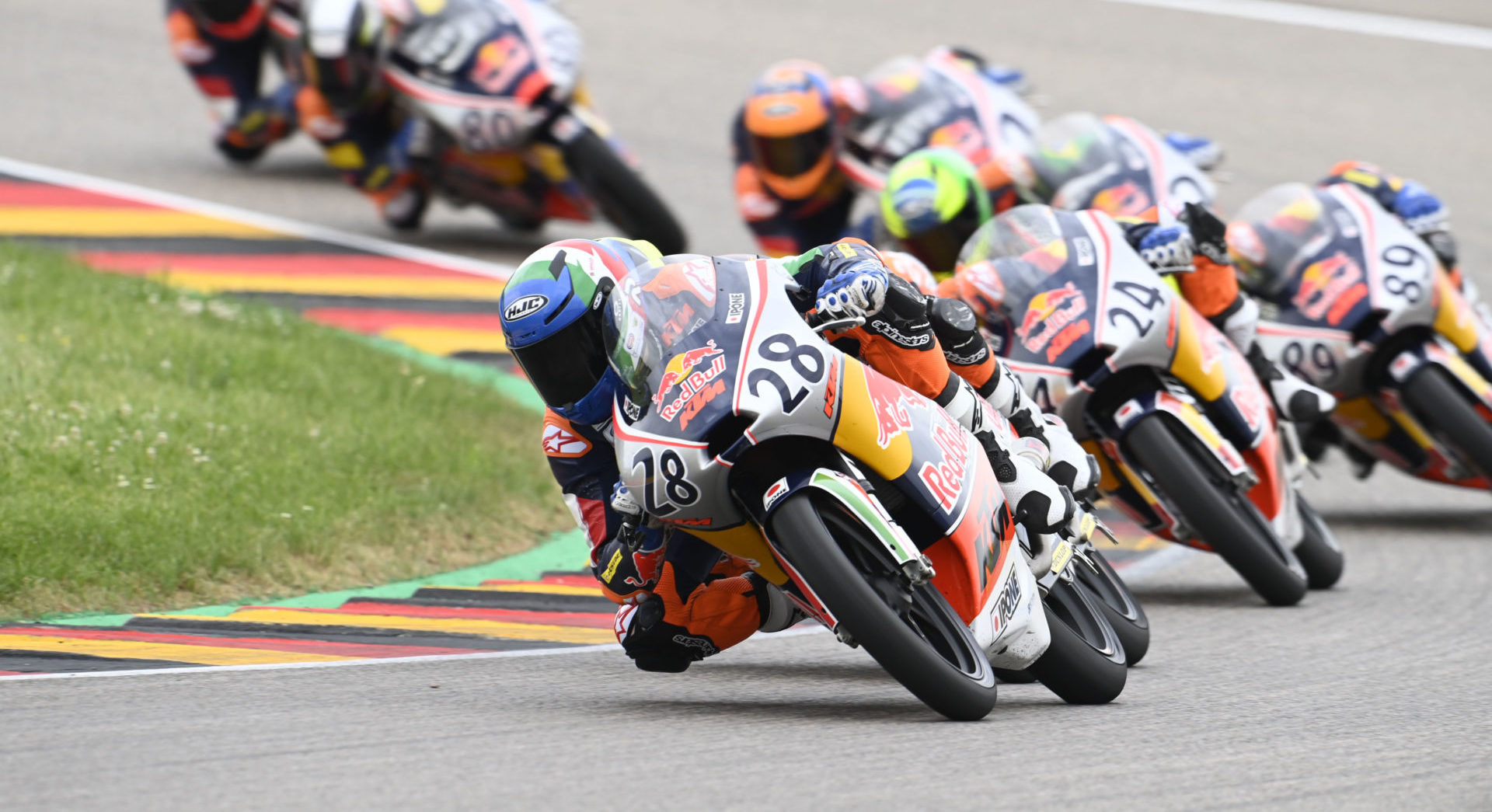 Matteo Bertelle (28) leads Ivan Ortola (24), Marcos Uriarte (89), and the rest of the Red Bull MotoGP Rookies Cup field during Race Two at Sachsenring. Photo courtesy Red Bull.