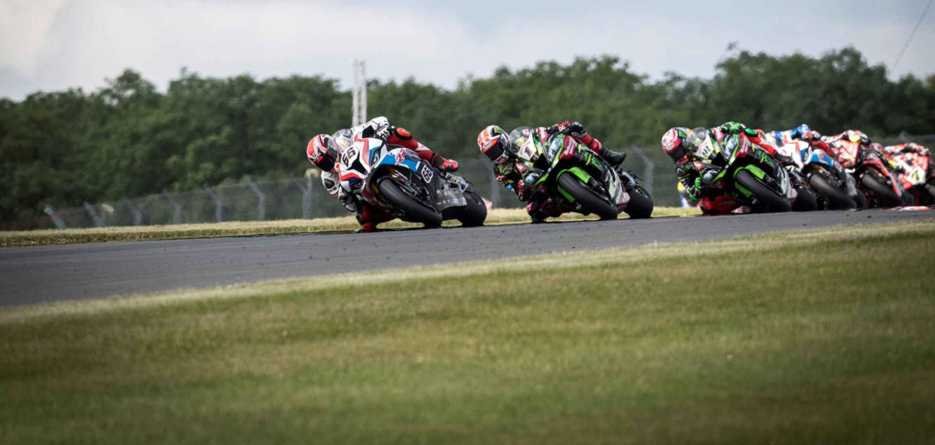 Tom Sykes (66) leads Jonathan Rea (1), Leon Haslam (91) and others during a World Superbike race at Donington Park in 2019. Photo courtesy BMW Motorrad Motorsport.