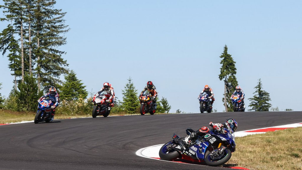 Jake Gagne (32) leads Cameron Petersen (45), Loris Baz (76), Mathew Scholtz (11), Josh Herrin (2), and Bobby Fong (50) early in Superbike Race One. Photo by Brian J. Nelson, courtesy MotoAmerica.