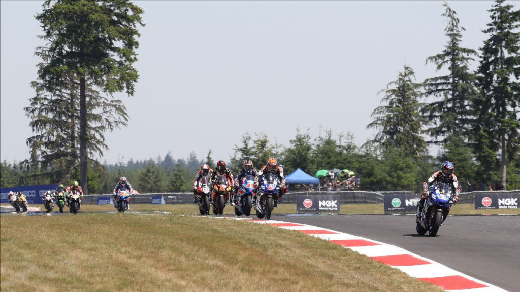 Jake Gagne (32) leads Josh Herrin (2), Cameron Petersen (32), Mathew Scholtz (11), Loris Baz (76), Bobby Fong (50), and the rest of the field early in Superbike Race Two at Ridge Motorsports Park. Photo by Brian J. Nelson, courtesy MotoAmerica.