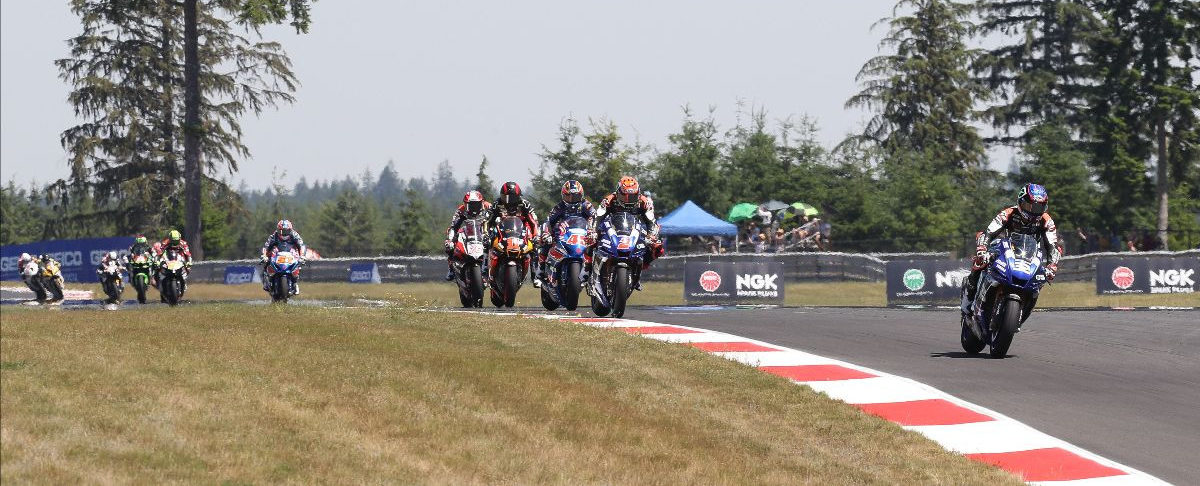 Jake Gagne (32) leads Josh Herrin (2), Cameron Petersen (32), Mathew Scholtz (11), Loris Baz (76), Bobby Fong (50), and the rest of the field early in Superbike Race Two at Ridge Motorsports Park. Photo by Brian J. Nelson, courtesy MotoAmerica.