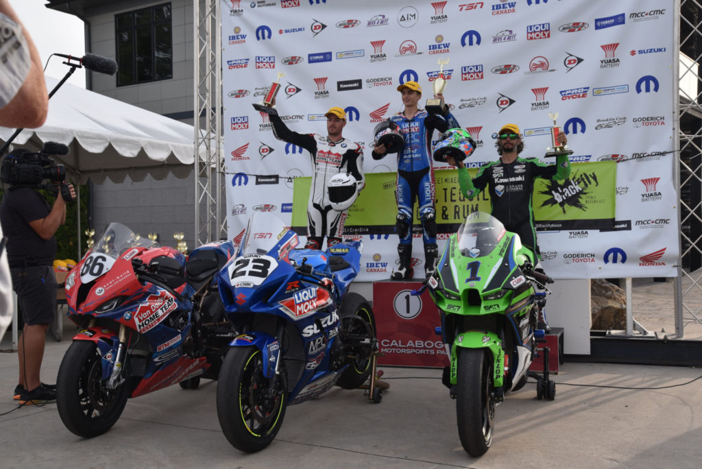 Alex Dumas (center) celebrates winning his debut CSBK race on the podium at Calabogie. Photo by Anik Sanfacon.