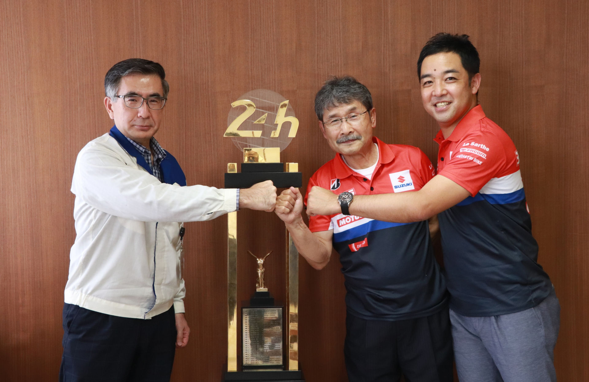 Toshihiro Suzuki, Representative Director and President of Suzuki Motor Corporation (left) accepts the 24 Hours of Le Mans first-place trophy from Yoshimura SERT Motul's Fujio Yoshimura (center) and Yohei Kato (right) and Suzuki Motor Corporation headquarters in Japan. Photo courtesy Team Suzuki Press Office.