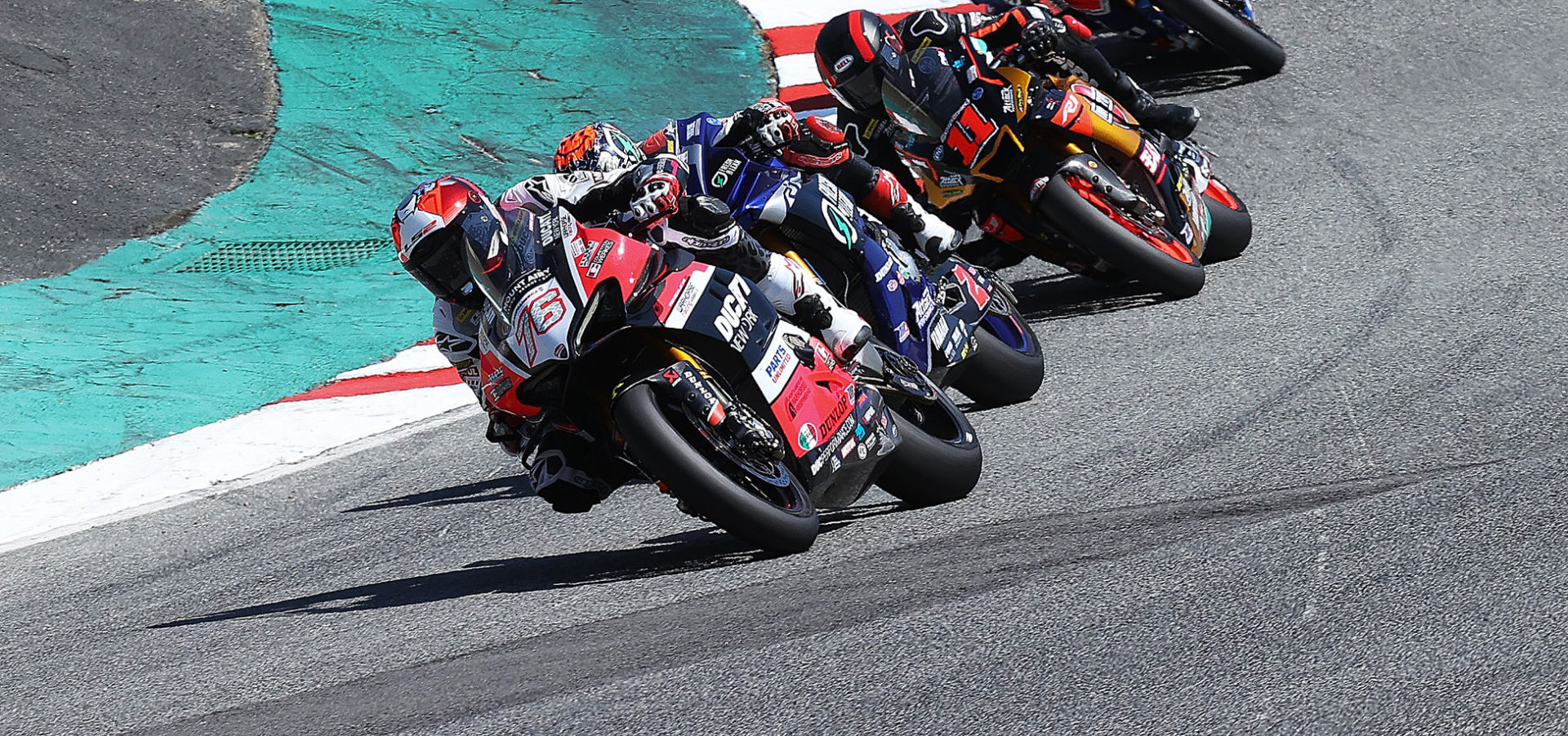 Loris Baz (76) leads Josh Herrin (2), Mathew Scholtz (11) and Bobby Fong (50) At Laguna Seca. Photo by Brian J. Nelson.