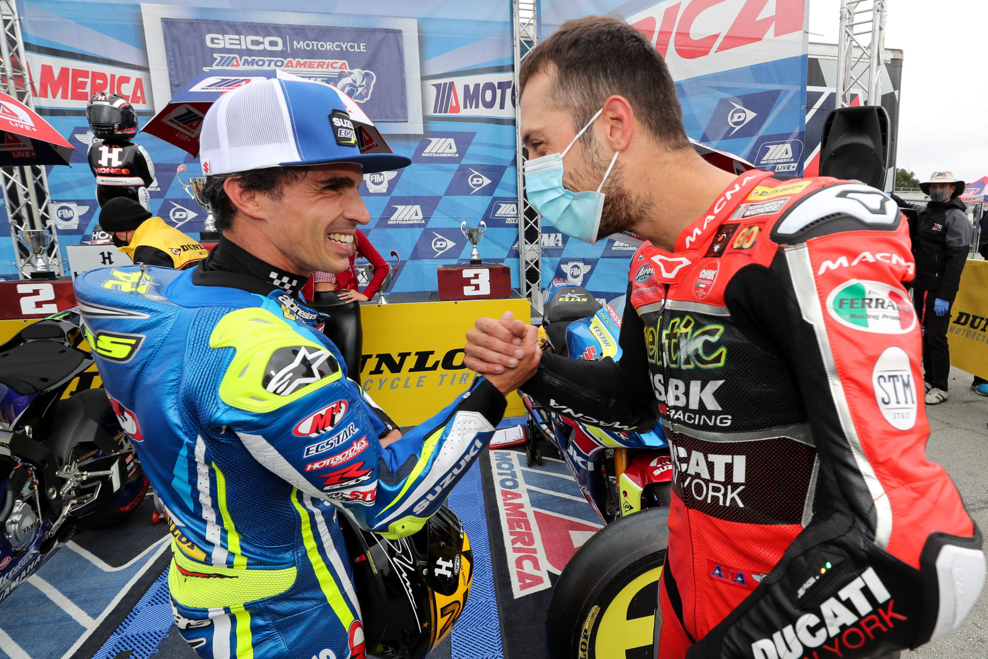 Toni Elias (left) shakes hands with Lorenzo Zanetti (right) after they finished third and second, respectively, in MotoAmerica Superbike Race Two at Laguna Seca in 2020. Photo by Brian J. Nelson.