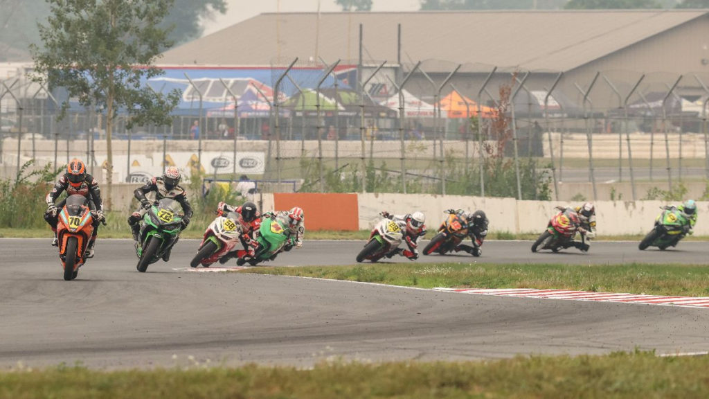 Tyler Scott (70) leads eventual winner Ben Gloddy (72) and the rest of the SportbikeTrackGear.com Junior Cup class at BIR. Photo by Brian J. Nelson