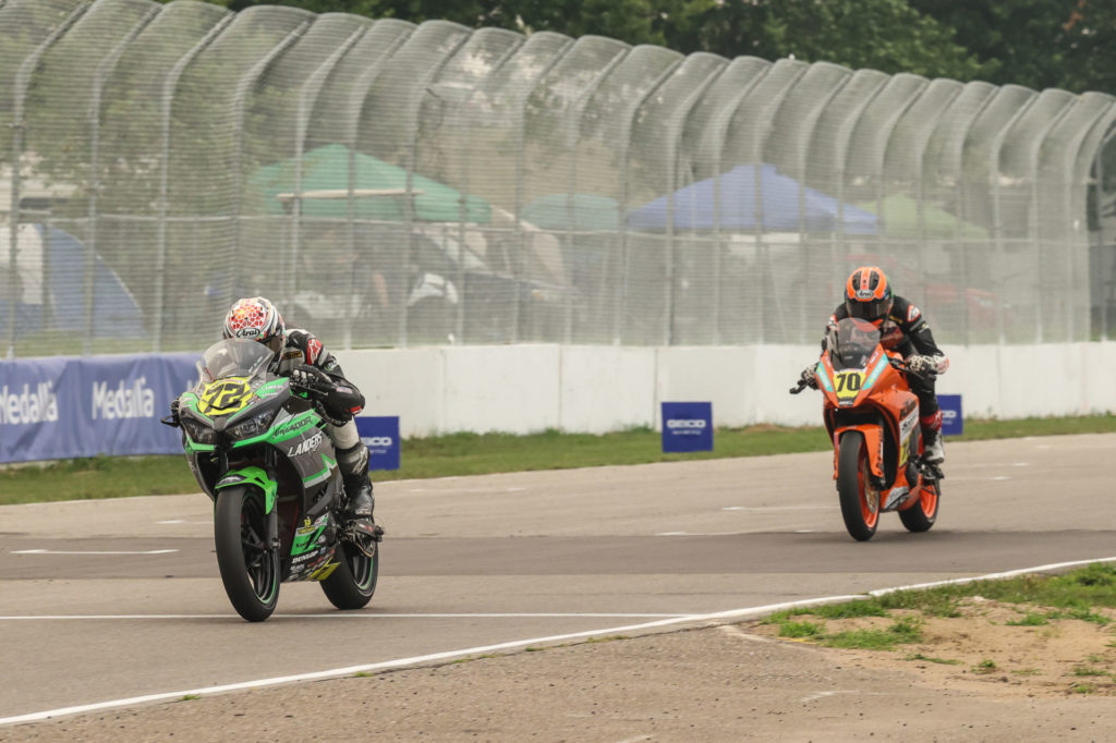 Ben Gloddy (32) leads Tyler Scott (70) during a MotoAmerica Junior Cup race at Brainerd. Photo by Brian J. Nelson, courtesy Landers Racing.