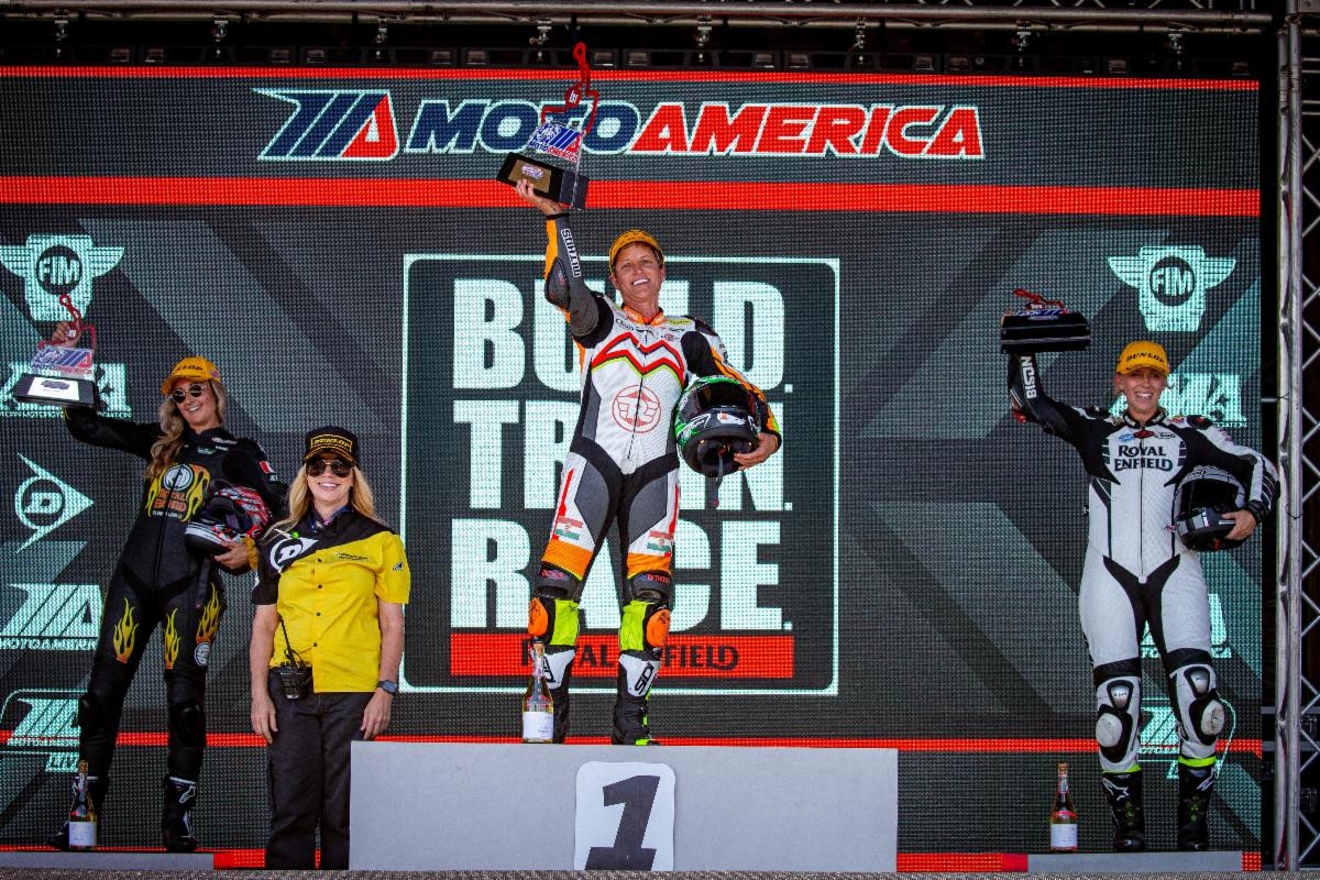 (L-R) Becky Goebel, CJ Lukacs and Trisha Dahl celebrate on the BTR podium at Brainerd International Raceway, round one of the Royal Enfield BUILD. TRAIN. RACE. Road Race exhibition.