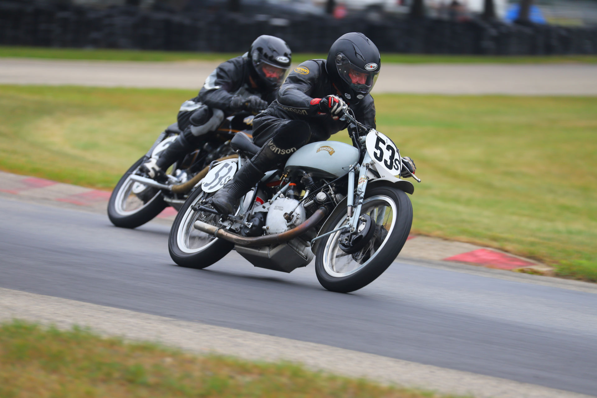 Scott Dell (53), riding a 1950 Vincent Comet, and Grant Spence, riding a 1950 AJS 350, at speed during the Class C Footshift race at Blackhawk Farms Raceway. Photo by etechphoto.com, courtesy AHRMA.