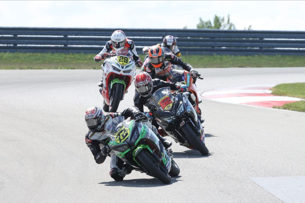 Ben Gloddy (72) leads Joseph LiMandri Jr. (62), Tyler Scott (behind LiMandri), and David Kohlstaedt (29) en route to winning SportbikeTrackGear.com Junior Cup Race One. Photo by Brian J. Nelson.