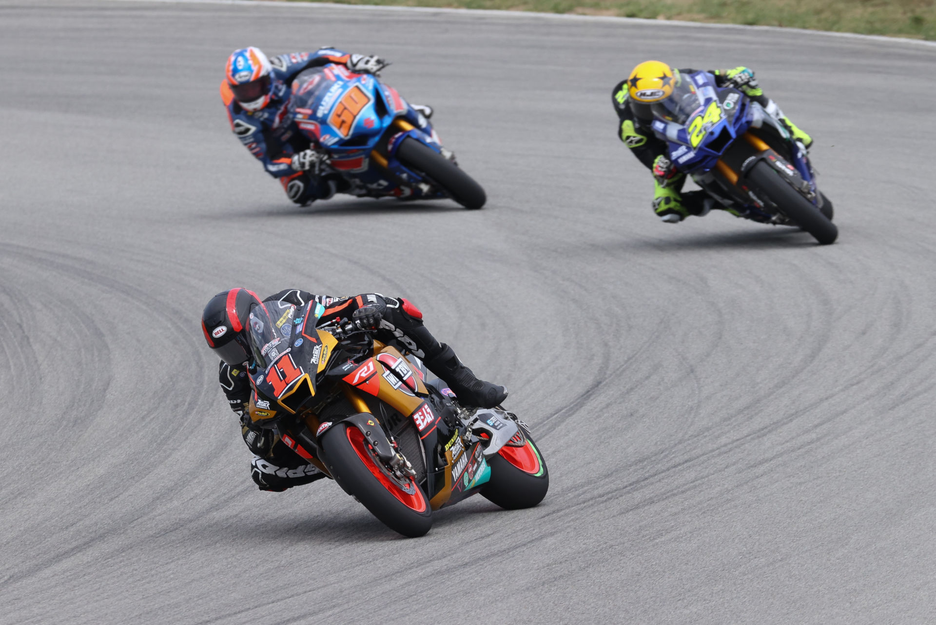 Mathew Scholtz (11) leads Toni Elias (24) and Bobby Fong (50) during MotoAmerica Superbike Race Two at PittRace. Photo by Brian J. Nelson, courtesy Westby Racing.