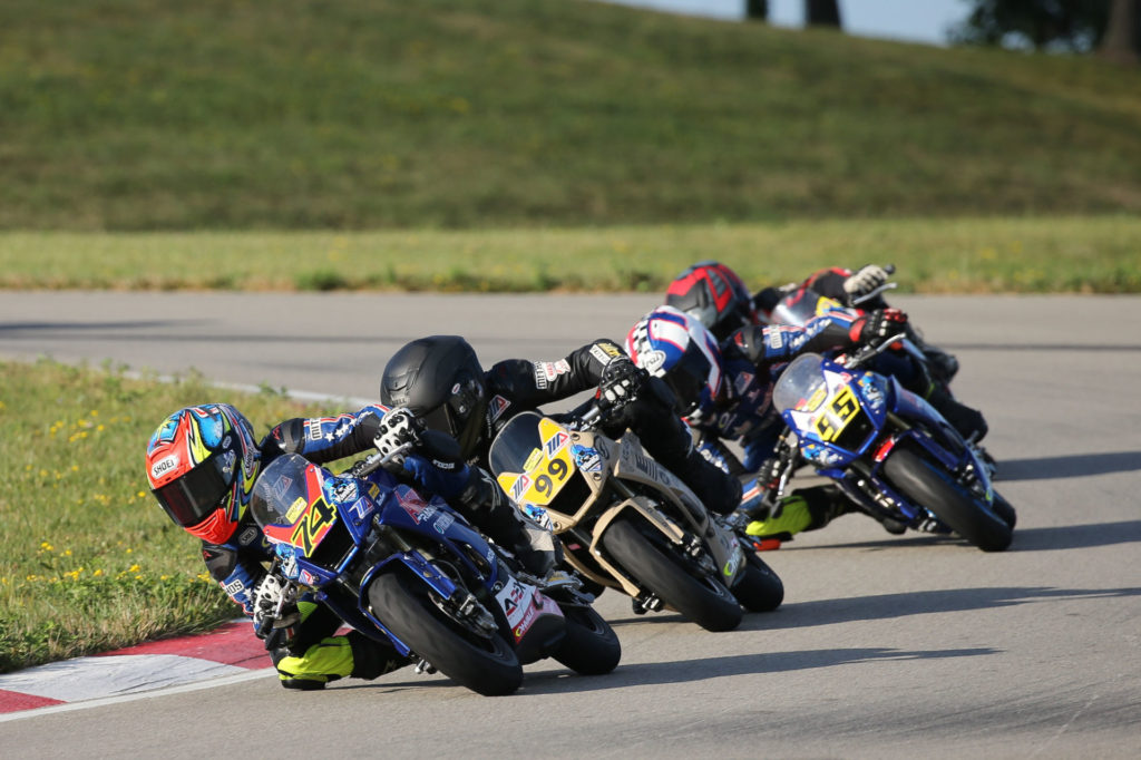 Kensei Matsudaira (74) leads Jesse James Shedden (99) en route to victory in the Mini Cup by Motul 160 class. Photo by Brian J. Nelson.