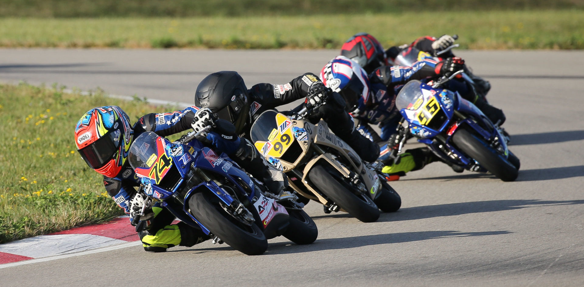 Kensei Matsudaira (74) leads Jesse James Shedden (99) en route to victory in the Mini Cup by Motul 160 class. Photo by Brian J. Nelson.