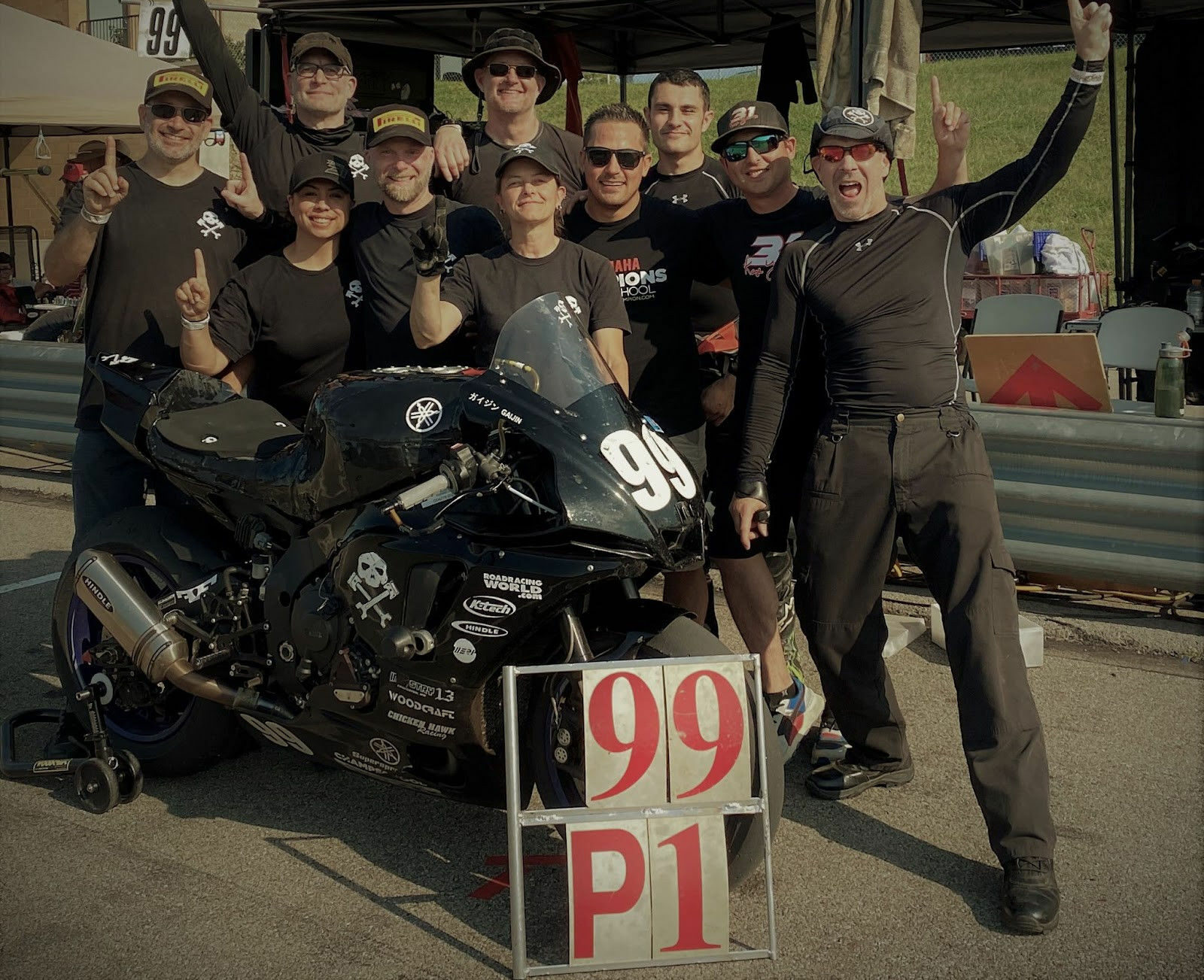 Army of Darkness (from left): Anthony Consorte, Chris Manfrin, Jen Vidad, YT Lechner, Tim Gooding, Melissa Berkoff, Chris Peris, Xavier Zayat, Ben Walters, Sam Fleming and “Gaijin” the Pirelli-shod Yamaha YZF-R1 endurance bike. Photo courtesy Army of Darkness.