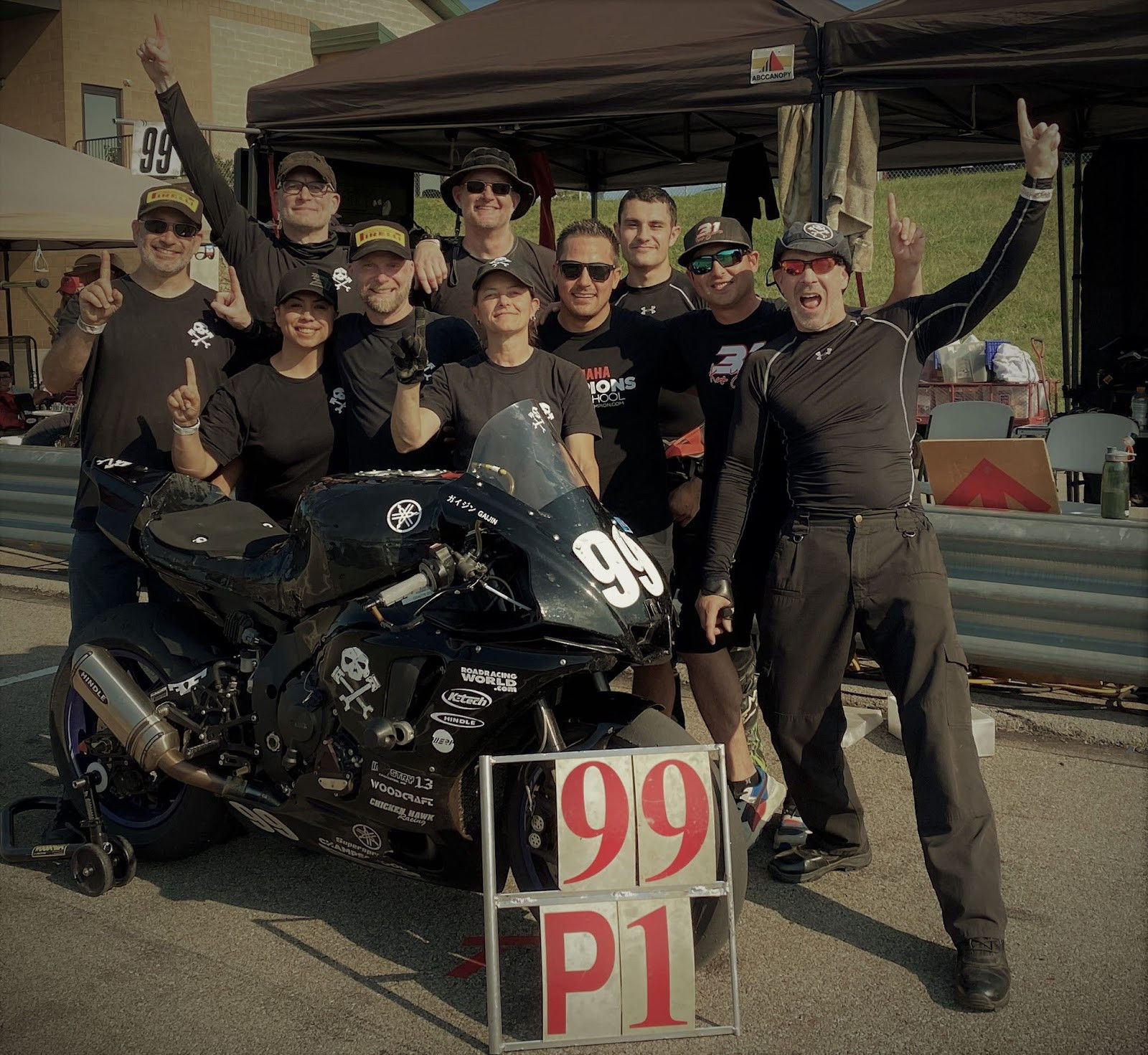 Army of Darkness (from left): Anthony Consorte, Chris Manfrin, Jen Vidad, YT Lechner, Tim Gooding, Melissa Berkoff, Chris Peris, Xavier Zayat, Ben Walters, Sam Fleming and “Gaijin” the Pirelli-shod Yamaha YZF-R1 endurance bike. Photo courtesy Army of Darkness.