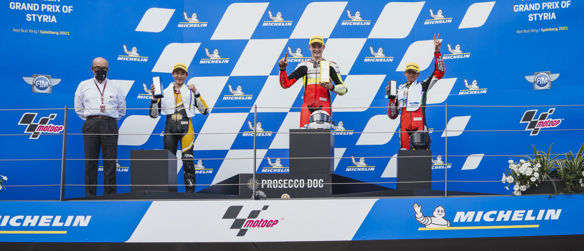 Hungarian-American Rossi Moor (center) on top of the Northern Talent Cup podium at Red Bull Ring. Moor is flanked by runner-up Lenoxx Phommara (left), third-place finisher Kevin Farkas (right), and Dorna CEO Carmelo Ezpeleta (far left). Photo courtesy Dorna.