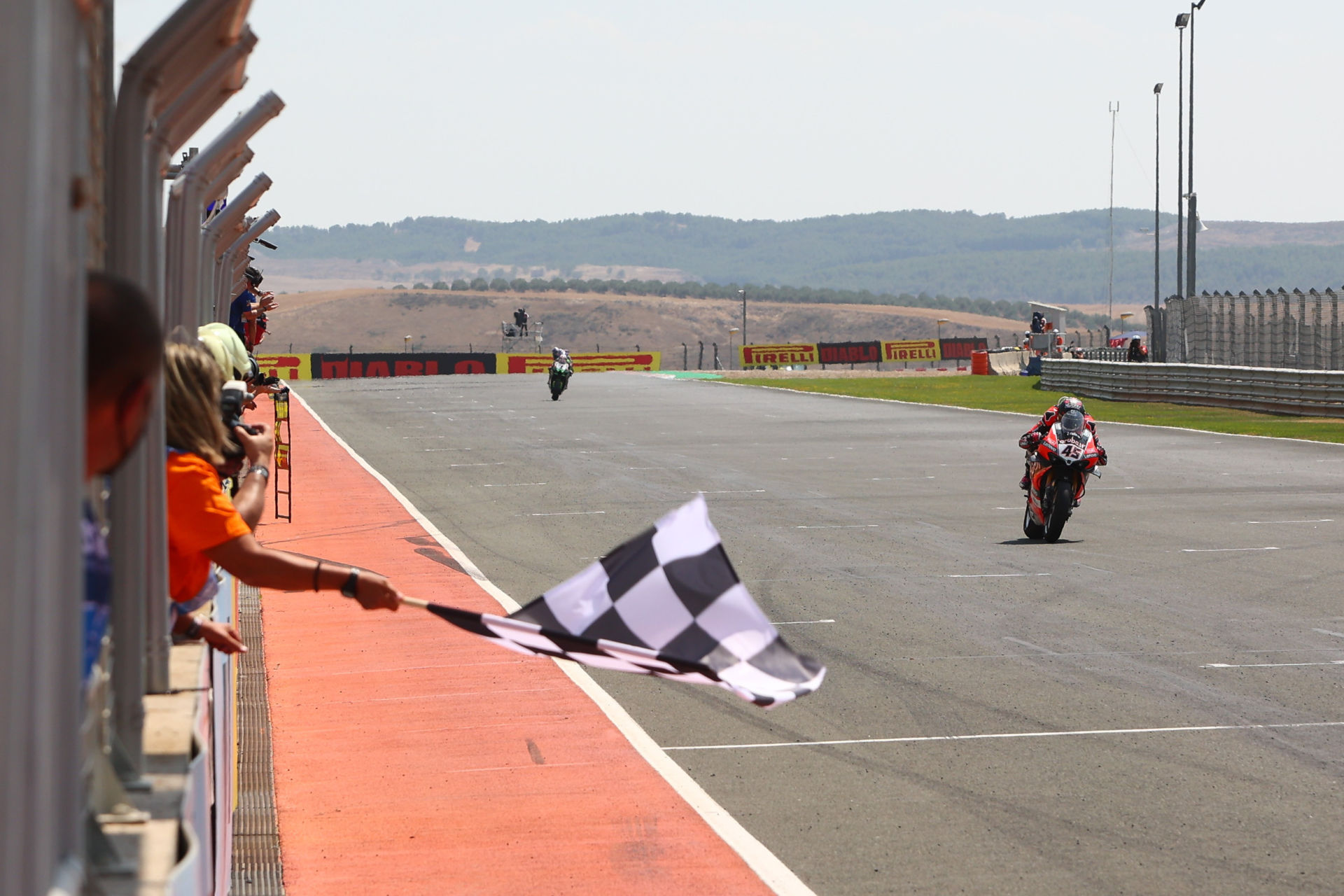 Scott Redding takes the checkered flag first in World Superbike Race One at Navarra. Photo courtesy Dorna.
