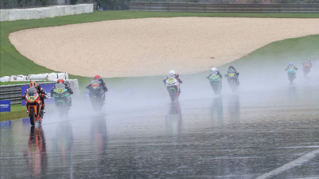 Tyler Scott (70) leads Ben Gloddy (72) and the rest of the field during the SportbikeTrackGear.com Junior Cup race, which was held in a rainstorm at Barber Motorsports Park. Photo by Brian J. Nelson, courtesy MotoAmerica.