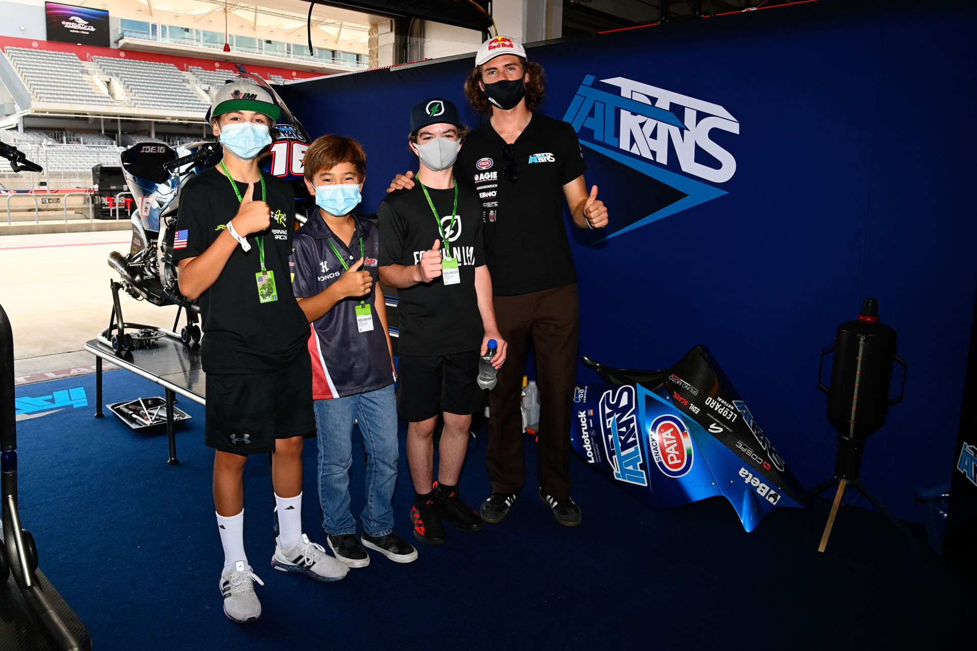 American Moto2 racer and MiniGP World Series ambassador Joe Roberts (far right) with FIM MiniGP North America stars (from left) Jayden Fernandez, Kensei Matsudaira, and Jesse James Shedden in the Italtrans Racing garage at COTA. Photo courtesy Dorna.